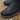 Black waterproof Crossover boots worn with beige trousers while standing on wet, muddy ground beside a puddle.