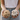 Person holding natural hemp fiber in one hand and raw cotton bolls in the other, standing outdoors in a green field.