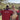 8000Kicks CEO outdoors with three members of a local Maasai community, surrounded by a rural landscape. Two people hold 8000Kicks T-shirts, while the CEO wears a beige 8000Kicks crossbody bag.
