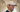 Bernardo, CEO and co-founder of 8000kicks, wearing a beige cap from his brand, smiling inside a hallway.
